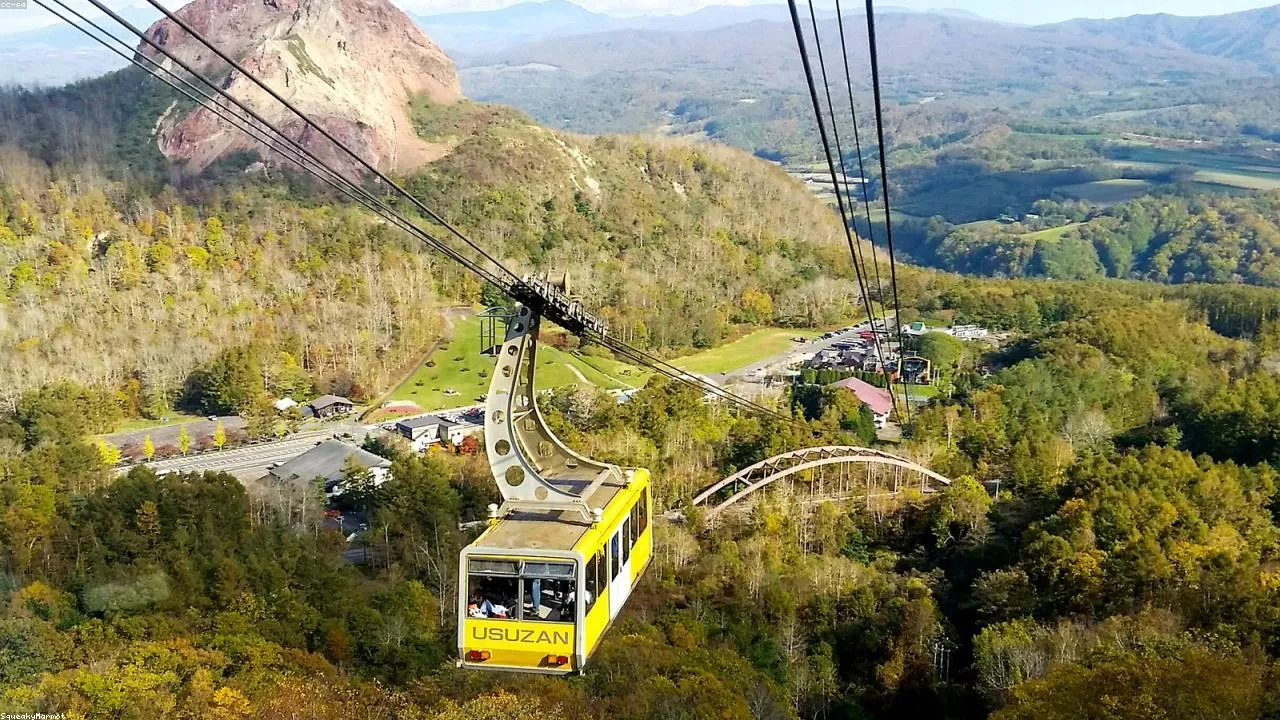 The Sarakurayama cable car ascending through forested slopes toward the mid-station