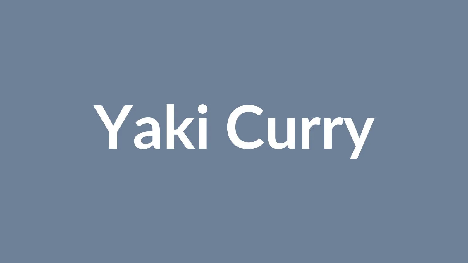 A cast-iron dish of yaki-curry — baked curry rice gratin topped with a golden egg, Mojiko's signature dish